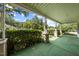 Covered front porch with green carpet and manicured hedges at 2631 Harvard Ave, Durham, NC 27703