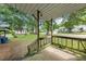 Open porch with wood railings overlooking the front yard and street at 2631 Harvard Ave, Durham, NC 27703