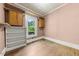 Empty room with wooden floor, light pink walls, and built-in shelves at 2631 Harvard Ave, Durham, NC 27703