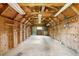 Spacious interior of a workshop with plywood walls, overhead lighting, and a concrete floor at 2631 Harvard Ave, Durham, NC 27703