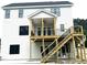 Backyard view featuring a large deck and staircase for outdoor living at 2651 Bowden Dr, Creedmoor, NC 27522