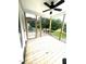 Relaxing covered porch with wood flooring, ceiling fan, and views of the serene backyard at 2651 Bowden Dr, Creedmoor, NC 27522