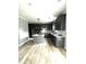 Modern kitchen with gray cabinets, hardwood floors, and a central island at 2651 Bowden Dr, Creedmoor, NC 27522