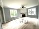 Bright living room features hardwood floors, a ceiling fan, and a modern fireplace at 2651 Bowden Dr, Creedmoor, NC 27522