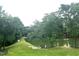 Scenic view of a pond surrounded by lush green trees and grassy areas at 2651 Bowden Dr, Creedmoor, NC 27522
