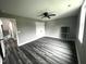 Spacious bedroom with gray walls, hardwood floors and large window at 2661 Bowden Dr, Creedmoor, NC 27522