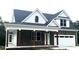 Charming exterior of a new two-story home with stone accents and a covered front porch at 2661 Bowden Dr, Creedmoor, NC 27522