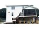 Exterior back view of home with screened porch, deck, staircase, and white siding at 2661 Bowden Dr, Creedmoor, NC 27522