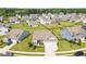 Aerial view of a charming two-story home with a well-manicured front yard and a two car garage at 3333 Jones Lake Rd, Fuquay Varina, NC 27526