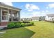 Well-manicured backyard with a screened-in porch and lush landscaping, offering a serene outdoor retreat at 3333 Jones Lake Rd, Fuquay Varina, NC 27526