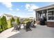 Outdoor patio with gray chairs, a grill, and a view of the well-maintained backyard and neighborhood at 3333 Jones Lake Rd, Fuquay Varina, NC 27526