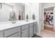 Bathroom featuring a double vanity, a large mirror and an opening to a well-organized walk-in closet at 3333 Jones Lake Rd, Fuquay Varina, NC 27526