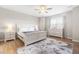 Serene bedroom showcasing a bright atmosphere with ample natural light, neutral colors and wood-look flooring at 3333 Jones Lake Rd, Fuquay Varina, NC 27526