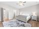 Bright bedroom features a ceiling fan, natural light, and en-suite access to the bathroom and a large walk-in closet at 3333 Jones Lake Rd, Fuquay Varina, NC 27526