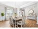 Elegant dining room featuring a table set for eight, wood flooring, and bright natural light at 3333 Jones Lake Rd, Fuquay Varina, NC 27526