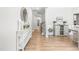 Bright entryway with wood floors, decorated console table, an attractive mirror, and staircase at 3333 Jones Lake Rd, Fuquay Varina, NC 27526