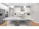 Contemporary kitchen featuring white cabinets, granite countertops, a spacious island and stainless appliances at 3333 Jones Lake Rd, Fuquay Varina, NC 27526