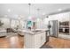 Bright, open kitchen features stainless steel appliances, granite countertops, and a seamless view into the living room at 3333 Jones Lake Rd, Fuquay Varina, NC 27526