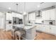 Modern kitchen with white cabinets, stainless steel appliances, granite countertops, and a spacious island at 3333 Jones Lake Rd, Fuquay Varina, NC 27526
