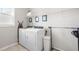 Functional laundry room featuring a side-by-side washer and dryer, plus added shelving at 3333 Jones Lake Rd, Fuquay Varina, NC 27526