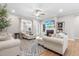 Comfortable living room showcasing neutral tones, a ceiling fan, and natural light streaming through the windows at 3333 Jones Lake Rd, Fuquay Varina, NC 27526