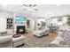 Inviting living room with a cozy fireplace, ceiling fan, and plush seating, creating a warm atmosphere at 3333 Jones Lake Rd, Fuquay Varina, NC 27526
