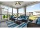 Relaxing sunroom with comfortable seating, a ceiling fan, and a view of the backyard at 3333 Jones Lake Rd, Fuquay Varina, NC 27526