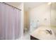 Bathroom with tiled flooring featuring a sink vanity with light countertop, toilet, and shower with striped curtain at 3403 Cardinal Lake Dr, Durham, NC 27704