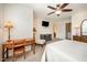 Bedroom with carpet flooring and desk set up is lit by lamp and ceiling fan; bathroom attached at 3403 Cardinal Lake Dr, Durham, NC 27704