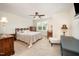 Bedroom with carpet flooring and a window is furnished with a bed, desk, nightstand, and chair at 3403 Cardinal Lake Dr, Durham, NC 27704
