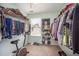 A walk-in closet filled with clothes and shoe racks, plus an exercise bike by the window at 3403 Cardinal Lake Dr, Durham, NC 27704