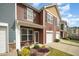 The townhome features a private entrance, front porch, and a well-maintained lawn at 3403 Cardinal Lake Dr, Durham, NC 27704
