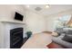Cozy living room with a fireplace, large window, and comfortable sofa at 3403 Cardinal Lake Dr, Durham, NC 27704