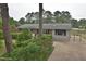 Inviting home exterior with manicured landscaping, mature trees, and a spacious driveway at 3610 Lambert Ln, Rocky Mount, NC 27804