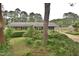 Well-manicured front yard with lush greenery, mature trees, and a charming home facade at 3610 Lambert Ln, Rocky Mount, NC 27804