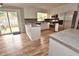 Well-lit kitchen boasts white cabinets, stainless appliances, and bar seating with a sliding glass door at 3610 Lambert Ln, Rocky Mount, NC 27804