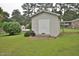 Well-maintained storage shed with double doors and a small ramp, set in a lush green yard at 3610 Lambert Ln, Rocky Mount, NC 27804