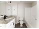 Modern bathroom with granite countertop, sleek fixtures, and a tub with white tiling at 404 Shannonford Ct, Wake Forest, NC 27587