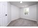 A simple bedroom design that features carpeted flooring and natural lighting from a window at 404 Shannonford Ct, Wake Forest, NC 27587
