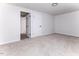 Spacious bedroom with plush carpet, neutral walls, and two entry doors at 404 Shannonford Ct, Wake Forest, NC 27587