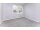 Cozy carpeted bedroom with a bright window and neutral color scheme at 404 Shannonford Ct, Wake Forest, NC 27587