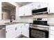 Modern kitchen featuring white cabinets, stainless steel appliances, and granite countertops at 404 Shannonford Ct, Wake Forest, NC 27587