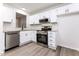 Modern kitchen with white cabinets, stainless steel appliances, and a stylish backsplash at 404 Shannonford Ct, Wake Forest, NC 27587