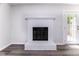 Bright living room featuring sleek floors and a cozy white brick fireplace at 404 Shannonford Ct, Wake Forest, NC 27587