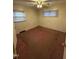 This is a bedroom with a ceiling fan and two windows with blinds at 603 Pineland St, Sanford, NC 27330