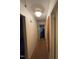 Hallway with doors leading to other rooms, featuring overhead lighting and neutral wall paint at 603 Pineland St, Sanford, NC 27330