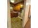 Close view of the kitchen showing stained cabinets and dated flooring at 603 Pineland St, Sanford, NC 27330