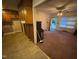 View from the kitchen into the living room that features stained carpet at 603 Pineland St, Sanford, NC 27330
