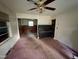 Living room with stained carpet and a piano visible at 603 Pineland St, Sanford, NC 27330