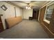 Spacious living room with exposed brick, carpeted floor, and natural light streaming through the windows at 603 Pineland St, Sanford, NC 27330